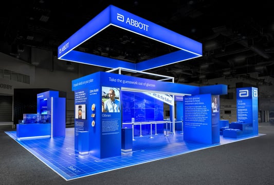 Abbott blue-branded interactive trade show booth with overhead illuminated canopy structure at CES 2026