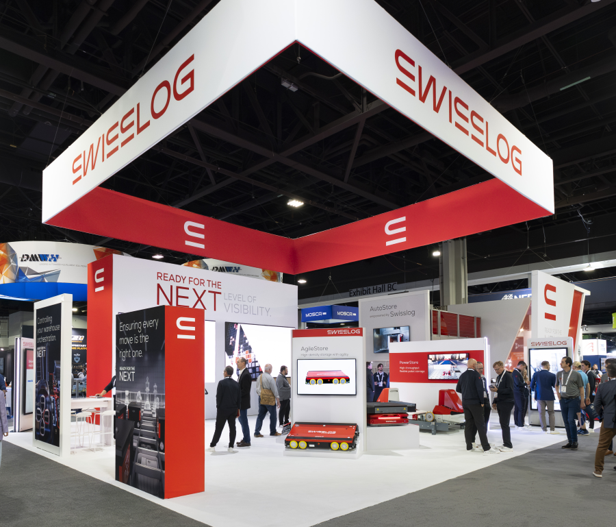 40x700 custom trade show booth for Corma featuring integrated industrial machinery and overhead branding
